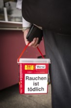 DEU Germany Germany Berlin Man with tobacco box at a market in Buckow