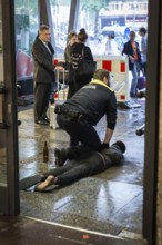 DEU Germany Germany Berlin BVG security staff hold a man on the ground at Zoo station