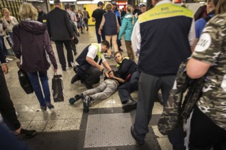 DEU Germany Germany Berlin BVG security staff hold a man on the ground in the subway at Zoo station