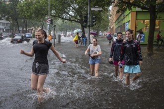 DEU Germany Germany Berlin Scene of the storm in Berlin. Young people cross the flooded