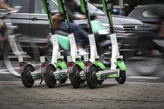 DEU Germany Germany Berlin Traffic passes parked e-scooters on Karl-Liebknecht-Str