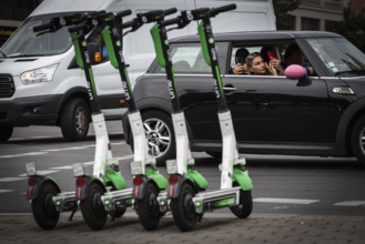 DEU Germany Germany Berlin Traffic passes parked e-scooters on Karl-Liebknecht-Str
