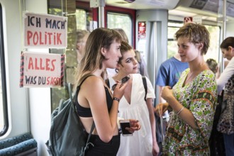 DEU Germany Germany Berlin Students discuss the G20 summit on the Berlin S-Bahn. A loose group of