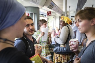 DEU Germany Germany Berlin Students discuss the G20 summit on the Berlin S-Bahn. A loose group of