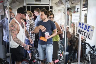 DEU Germany Germany Berlin Students discuss the G20 summit on the Berlin S-Bahn. A loose group of