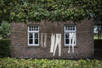 DEU Germany Germany Moordorf Historic clothing hangs on a washing line at the Moor Museum. The