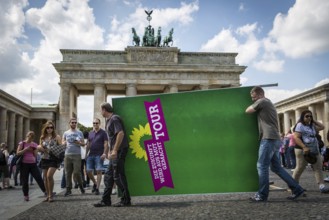 DEU Germany Germany Berlin Two men carry a Green Party billboard across Pariser Platz. After a