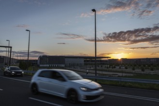 DEU Germany Germany Berlin Cars pass the future BER Berlin-Brandenburg airport at sunset