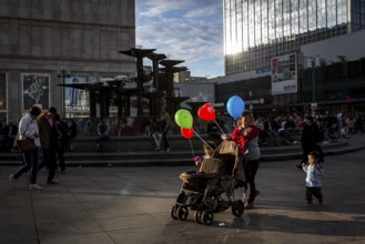 DEU Germany Germany Berlin People in the light at Alexanderplatz