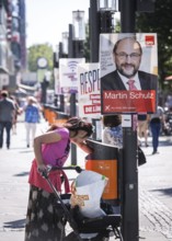 DEU Germany Germany Berlin A woman searches for recyclables in the rubbish bin in front of election