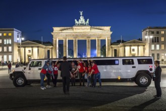 DEU Germany Germany Berlin Bride with friends posing in front of stretch limousine in front of the