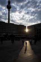 DEU Germany Germany Berlin People in the light at Alexanderplatz
