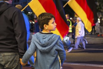 DEU Germany Germany Dresden Pegida demonstration in the city centre. Father and son trying to cross
