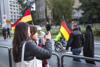 DEU Germany Germany Dresden Pegida demonstration in the city centre. Asian tourists take a photo of