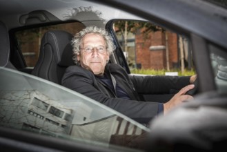 DEU Germany Germany Berlin Mobility researcher Andreas Knie in an electric vehicle on the EUREF