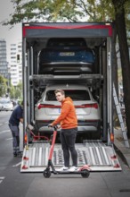 DEU Germany Germany Berlin SUVs with electric motors are loaded onto a transporter in Kantstrasse.