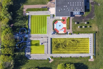Aerial view, outdoor swimming pool south in front of the opening of the season with algae in the