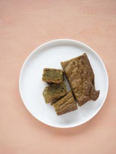 Group of matcha blondies on a white plate, prepared for a sweet treat