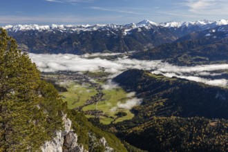 Snow on mountain range, fog over the village of Gröbming, view from Stoderzinken near Gröbming,