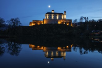 Moon over Trautenfels Castle, reflection in a lake, blue hour, near Irdning, Ennstal, Styria,