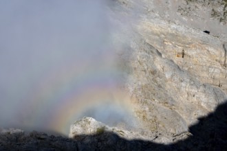 Rainbow in fog on the Steinernes Meer near the visible Wildalmkirchl bivouac, Berchtesgaden Alps,