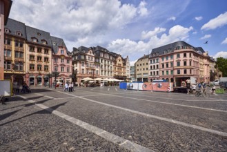 Square made of paving stones and marble slabs with pattern, row of houses, reconstructed historic
