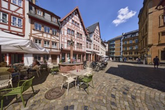 Marienbrunnen, stone fountain, historic half-timbered houses, buildings, bicycles, paving stone
