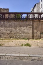 City fortification, historic city wall, general architecture, houses, parking lot, barrier bollard,