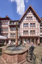 Marienbrunnen, stone fountain, historic half-timbered houses, bicycle, paving stone square, blue