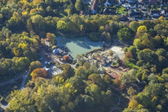 Aerial view, lake and autumn trees in Maximilianpark, children's playground and open-air stage,