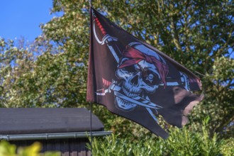 Pirate flag in a garden, Ahrenshoop, Darß, Mecklenburg-Western Pomerania, Germany