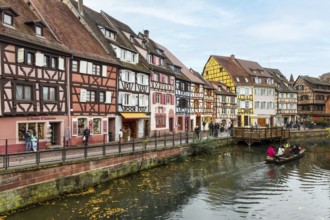 Traditional houses along a river here called the little Venice, with tourists visiting Colmar on a