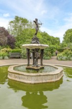 London, United Kingdom - 15 May 2025: Charming bronze Diana the Huntress fountain surrounded by