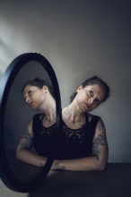 Portrait of a woman with a mirror, interior view