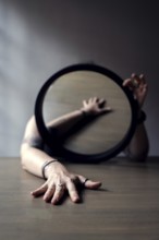 Portrait of a woman behind a mirror, interior view