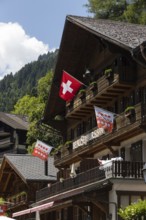 Chalets with a Swiss flag are pictured in Champery, a village in the mountains by the French border