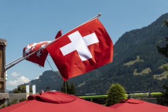 A flag of Switzerland pictured in Champery, a village by the French border with mountains at the