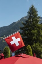 A flag of Switzerland pictured in Champery, a village by the French border with mountains at the