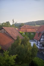 Rural countryside houses mingling with nature, ivy growing on walls, view of traditional Fachwerk