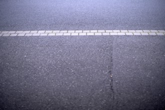 Weather conditions caused a crack in the street asphalt requiring public maintainance financed by