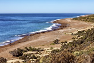 Coastal landscape with narrow beach and undulating sea under clear sky, The landscape of Peninsula