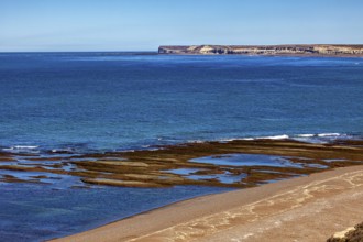 Rocky, cliff-rich coast with deep blue water and clear views, the landscape of Peninsula Valdes in