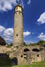 High stone tower against a cloudy blue sky, The Niedeck Ruins in Arnstadt Thuringia