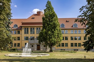 Historic building with tiled roof and fountain in the foreground, the old town of Arnstadt in