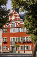 Magnificent building with remarkable façade, surrounded by trees, in bright weather, The old town