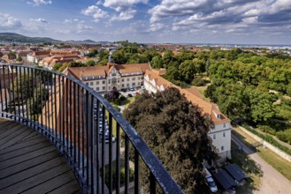 Extensive view of the city with buildings, trees and blue sky, the old town of Arnstadt in