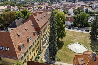 Aerial view of historic buildings with fountain and green area, The old town of Arnstadt in