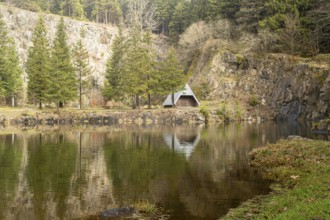 A hut reflected in calm water, Erfurt, Thuringia, Germany