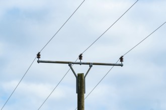 Borken, nrw, germany, utility pole holding electrical power lines against cloudy sky