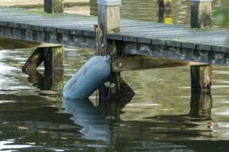 Borken, nrw, germany, buoy attached to old wooden dock over water, Borken, nrw, germany
